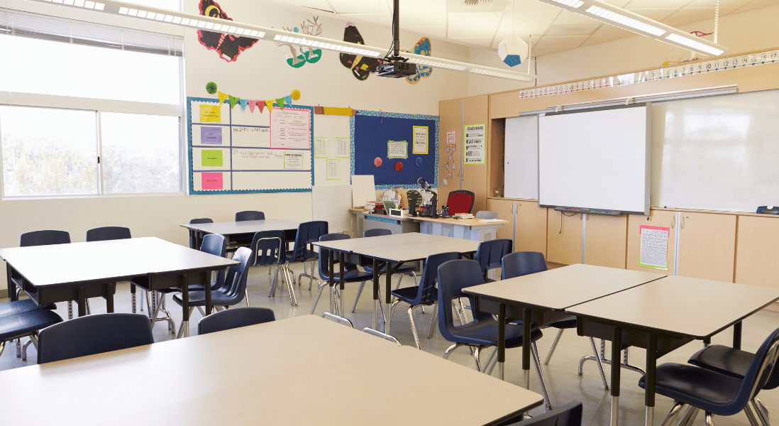 empty classroom with table , chairs and white board
