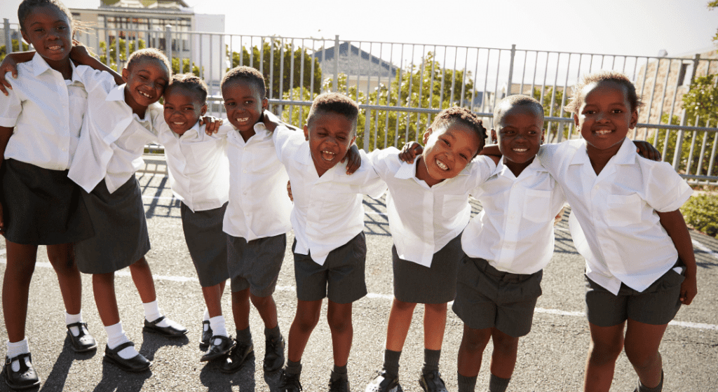 black students including boys and girls wearing a grey and white school uniform
